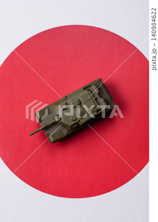 A tank on the Japanese flag as a conceptual backdrop representing defense 140984622