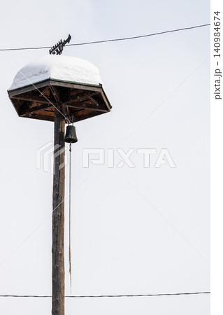 snow-covered old wooden tower with fire alarm bell snow-covered old wooden tower with fire alarm bell 140984674