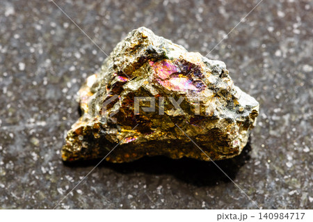 ough chalcopyrite rock close-up on black granite ough chalcopyrite rock close-up on black granite 140984717