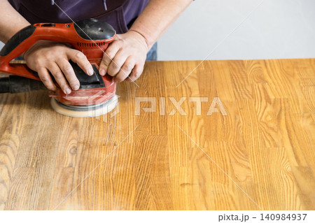 worker polishes table using polishing machine worker polishes table using polishing machine 140984937