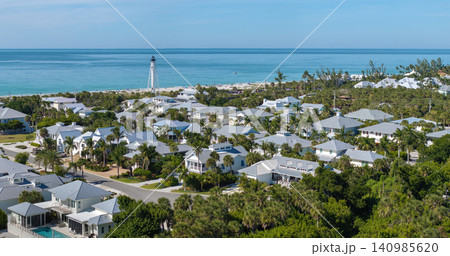 Large residential homes and tall lighthouse in island small town Boca Grande on Gasparilla Island in southwest Florida. American waterfront houses in rural US suburbs Large residential homes and tall lighthouse in island small town Boca Grande on Gasparilla Island in southwest Florida. American waterfront houses in rural US suburbs 140985620