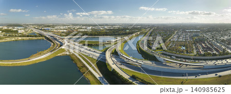 American big freeway intersection in Miami, Florida with fast moving cars and trucks. USA transportation infrastructure concept American big freeway intersection in Miami, Florida with fast moving cars and trucks. USA transportation infrastructure concept 140985625