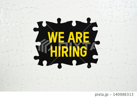 Jigsaw puzzle with a missing piece with "We Are Hiring" on black background Jigsaw puzzle with a missing piece with "We Are Hiring" on black background 140986313