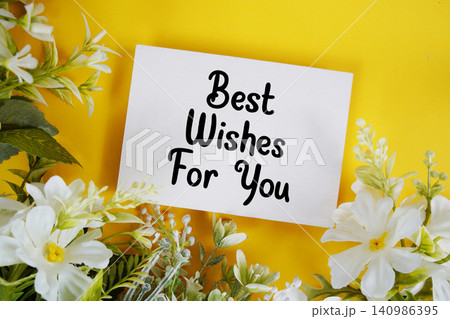 Best Wishes For You text written on paper card with flowers decoration on blue background Best Wishes For You text written on paper card with flowers decoration on blue background 140986395