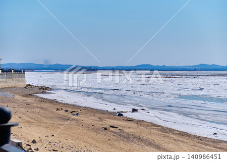 Urban landscape of Khabarovsk riverbank featuring melting ice and clear sky Urban landscape of Khabarovsk riverbank featuring melting ice and clear sky 140986451