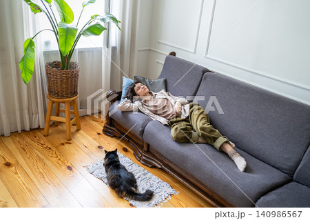 Home comfort, laziness and idling, tranquil woman quietly napping lying on couch in living room. Home comfort, laziness and idling, tranquil woman quietly napping lying on couch in living room. 140986567