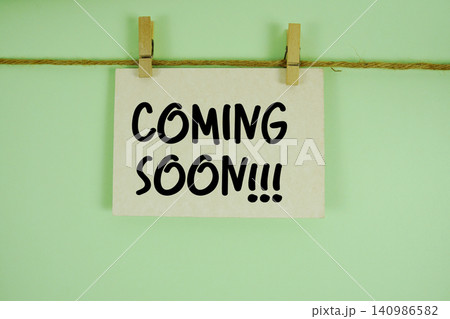 Coming Soon paper notes hanging on the rope with clothespins Coming Soon paper notes hanging on the rope with clothespins 140986582