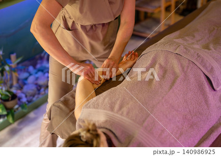 Healing manual body therapy in spa salon, woman client receiving deep body massage from masseuse. Healing manual body therapy in spa salon, woman client receiving deep body massage from masseuse. 140986925