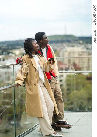 Carefree stylish african american travelers man and woman visiting new city on vacation together. Carefree stylish african american travelers man and woman visiting new city on vacation together. 140987034