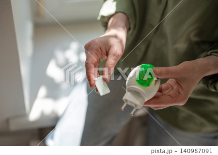 Woman using anti mosquito fumigator at home, electrical repellent device against insect problems Woman using anti mosquito fumigator at home, electrical repellent device against insect problems 140987091