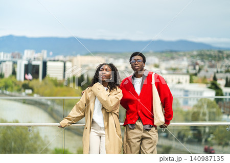 Relaxed african american married travelers on sightseeing spree in new city enjoying view. Relaxed african american married travelers on sightseeing spree in new city enjoying view. 140987135