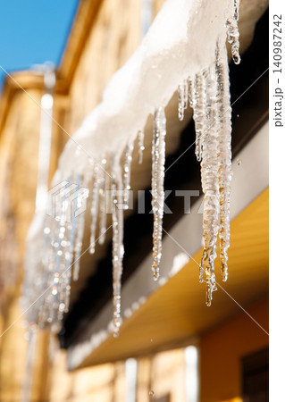 Building covered with icicles in sunny winter day 140987242