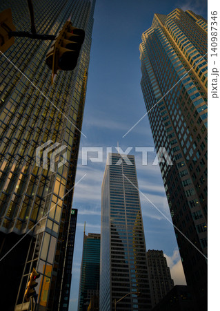 Golden Glass Towers Rising Into Blue Sky Upward View 140987346