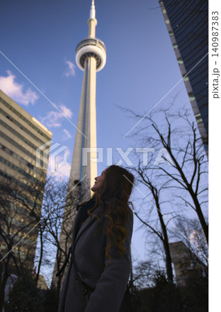 Tourist Admires Landmark Tower Through Bare Branches Tourist Admires Landmark Tower Through Bare Branches 140987383