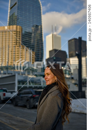 Smiling Woman Enjoys Sunset View Of City Skyline Smiling Woman Enjoys Sunset View Of City Skyline 140987406
