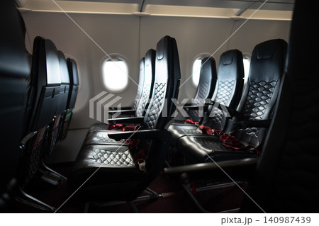 Empty passenger airplane seats in the cabin. Deserted economy class airplane seats rows. 140987439