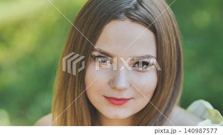Portrait of a young girl in a park. Close-up of her face. 140987577