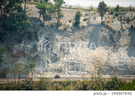 Work to strengthen mountain slope from landslides and rockfall with special metal netting. Work to strengthen mountain slope from landslides and rockfall with special metal netting. 140987648