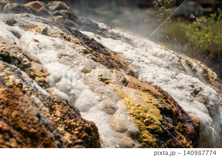 Hot springs in Thailand, natural streams with clean mineral-rich water flowing over stone surfaces. Hot springs in Thailand, natural streams with clean mineral-rich water flowing over stone surfaces. 140987774