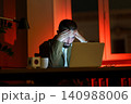 Confused young businessman at night office work at laptop computer exhausted and tired of deadlines 140988006