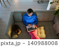 Woman freelancer on cozy sofa works at project typing information on laptop. Cat sleeps nearby 140988008