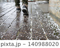 Closeup of technical salt grains on icy sidewalk surface in winter, used for melting ice and snow. 140988020