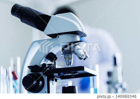 Science microscope equipment in biology chemical laboratory. Scientific experiment Microscope on Lab table microbiology equipment. Chemistry objects on lab background. Chemistry scientific concept 140988346