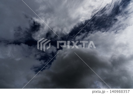 Dark rain cloud dramatic sky summer tropical thunder storm sky and fluffy black darkness cloud nearly raining cloudscape. Nimbus raincloud skyline climate background. Dark gray sky cloudy environment 140988357