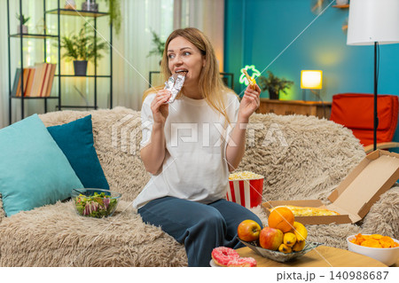 Pregnant woman craves pizza chocolate fruit chips popcorn wants to eat all hunger during pregnancy Pregnant woman craves pizza chocolate fruit chips popcorn wants to eat all hunger during pregnancy 140988687