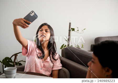 Teenager Taking a Selfie at the Table 140989223