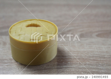 Round yellow box on a light background Round yellow box on a light background 140991493
