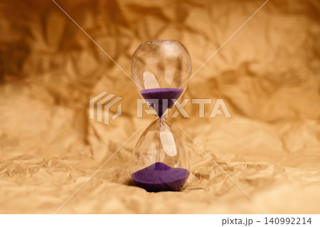 Hourglass with senior age blocks on crumpled pape,aging society, retirement and passing lifetime Hourglass with senior age blocks on crumpled pape,aging society, retirement and passing lifetime 140992214