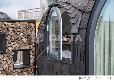 Modern Glamping Cabin with Wooden Shingles and Firewood Stack for Cozy Outdoor Travel Stay Modern Glamping Cabin with Wooden Shingles and Firewood Stack for Cozy Outdoor Travel Stay 140992884
