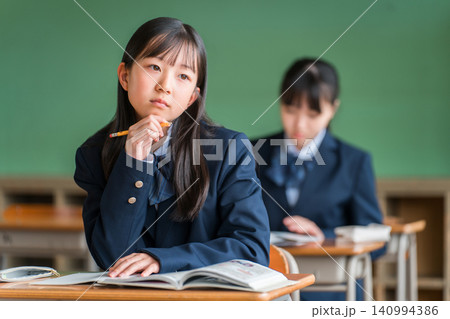 授業中に外を眺める中学生の女子生徒(進路・夢・思春期) 授業中に外を眺める中学生の女子生徒(進路・夢・思春期) 140994386