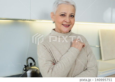 Portrait of confident stylish European middle aged senior woman. Older mature 60s lady smiling at home. Happy attractive senior female looking camera close up face headshot portrait. Happy people Portrait of confident stylish European middle aged senior woman. Older mature 60s lady smiling at home. Happy attractive senior female looking camera close up face headshot portrait. Happy people 140995751