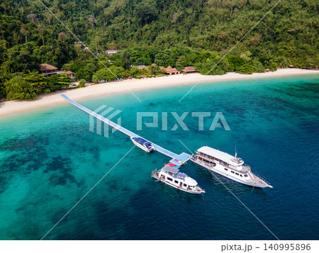 Aerial view of tropical beach landscape with tour boats at Nyaung Oo Phee island in Myanmar Aerial view of tropical beach landscape with tour boats at Nyaung Oo Phee island in Myanmar 140995896