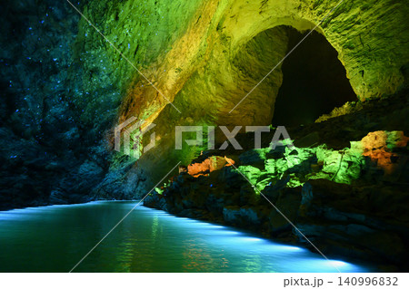 Underground river illuminated by colored light in huge Yellow Dragon Cave near Zhangjiajie, China Underground river illuminated by colored light in huge Yellow Dragon Cave near Zhangjiajie, China 140996832