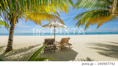 Twin sunbeds under a red parasol on palm beach. Turquoise sea framing a luxury island retreat. Tropical resort escape for travel destination summer holiday 140997742