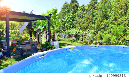 Outdoor swimming pool in a garden with lawn, plants and trees. Outdoor swimming pool in a garden with lawn, plants and trees. 140999218