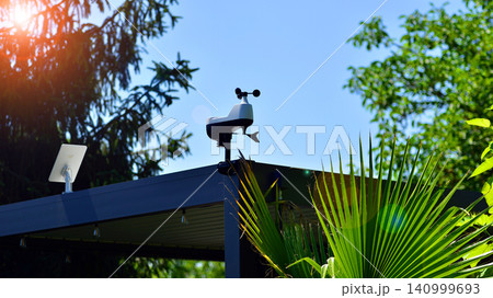 Weather station sensor installed on a pergola rooftop against a clear blue sky Weather station sensor installed on a pergola rooftop against a clear blue sky 140999693