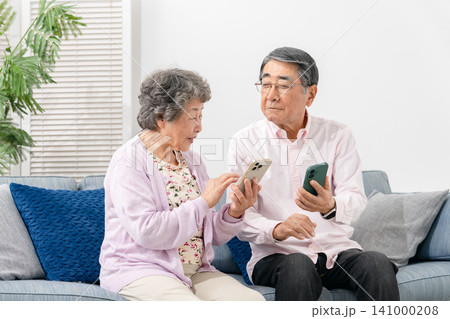 スマートフォンを持つシニア夫婦 141000208