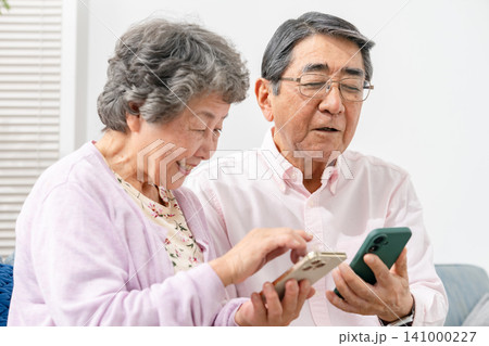 スマートフォンを持つシニア夫婦 141000227