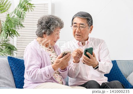スマートフォンを持つシニア夫婦 141000235
