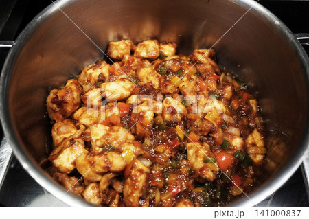 Fresh spicy stir fried crispy pork with red curry paste in aluminum bowl. Traditional Thai food 141000837