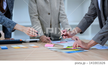 Creative Design Team Reviewing Color Swatches and Samples During Collaborative Brainstorming Meeting Creative Design Team Reviewing Color Swatches and Samples During Collaborative Brainstorming Meeting 141001826