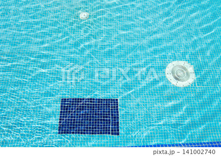Blue pool water with sun glare, background and texture of water with mosaic tiles Blue pool water with sun glare, background and texture of water with mosaic tiles 141002740