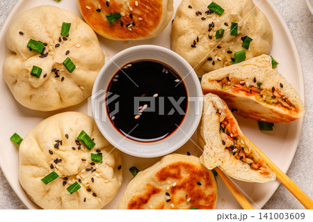 Delicious buns served on a plate with sauces and toppings Delicious buns served on a plate with sauces and toppings 141003609