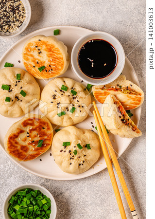Delicious buns served on a plate with sauces and toppings Delicious buns served on a plate with sauces and toppings 141003613