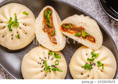 Steamed buns on a dark plate. Steamed buns on a dark plate. 141003629