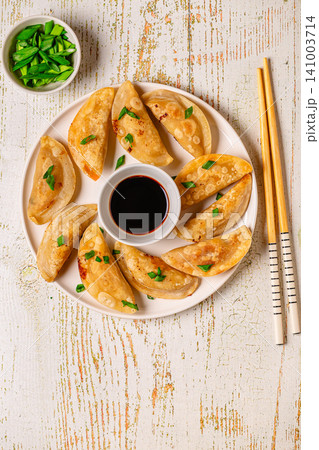 Dumplings served on a plate with soy sauce Dumplings served on a plate with soy sauce 141003714